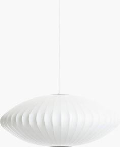 a large white light hanging from a ceiling