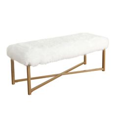 a white bench with wooden legs and a fur cover on it's backrest