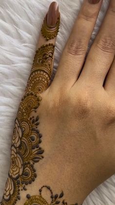 a woman's hand with henna on it