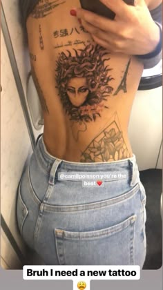 the back of a woman's stomach with tattoos on it and an image of a woman