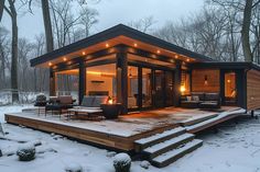 a small cabin in the snow with lights on it's porch and patio area