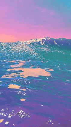 the water is very blue and purple with some bubbles on it's surface, as well as an ocean wave