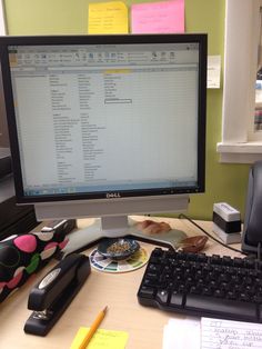 a desktop computer sitting on top of a wooden desk next to a keyboard and mouse