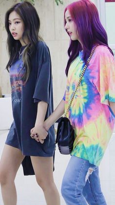 two girls are holding hands and walking down the street in tie - dyed outfits, one is wearing a t - shirt that says instagram