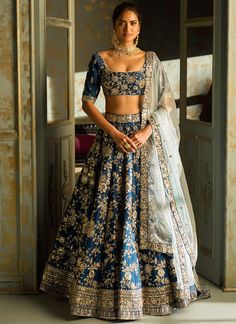 Our Dark Blue Embroidered Lehenga includes a silk top, silk with santoon inner bottom, and a net dupatta. Embroidery is present on this style using thread, zari, and stone work. Like all of our pieces, this piece is made in India and checked by hand to ensure high quality. Blue Bridal Lehenga, Reception Outfit, Indian Outfits Lehenga, Traditional Indian Dress, Indian Dresses Traditional, Embroidered Lehenga, Traditional Indian Outfits, Indian Lehenga, Bridal Lehenga Choli