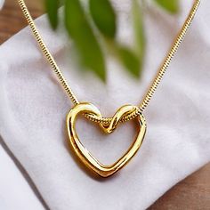 Elevate Your Style With This Stunning Dainty Gold Plated Heart Shape Pendant Necklace. This Charming And Elegant Necklace Is The Perfect Fashion Gift For The Stylish And Sophisticated Woman Who Loves All Things Love And Hearts. The Necklace Boasts A Beautiful Heart-Shaped Pendant Made Of High-Quality Alloy In A Striking Gold Color That Complements Any Outfit. The Necklace Measures 18 Inches In Length And Features A Pendant That Symbolizes Love And Warmth. Perfect For Any Occasion, This Necklace Jewelry Store Interior, Gold Ideas, Mangalsutra Design, Dancing Diamond, Black Beads Mangalsutra, Black Beads Mangalsutra Design, Heart Shaped Pendant Necklace, Peridot Pendant, Elegant Necklace