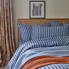 a bed with blue and white striped sheets