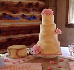 a three tiered cake sitting on top of a table next to other desserts