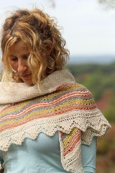 a woman wearing a white shawl and blue shirt