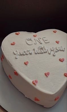 a heart shaped cake with writing on it