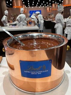 a large pot filled with chocolate on top of a table