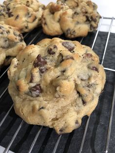 several chocolate chip cookies cooling on a rack