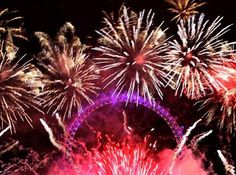 fireworks are lit up in the night sky over london's river thames and the eiffel tower