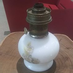 a white vase sitting on top of a wooden table