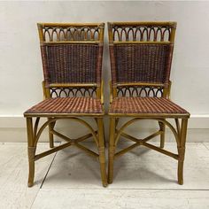 two wicker chairs sitting next to each other on a white tile floor in front of a wall