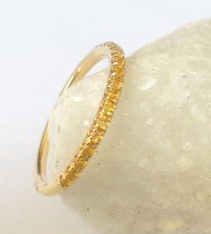 "Half Eternity Band Ring with Natural Citrine Gemstones. Material: Solid Gold (14K or 18K) Finish: High Polished/ Shiny Setting Type: U Micro Pave (Reminds letter \"U\") Stone: Natural Citrine Shape and Cut: Round, Diamond Cut Total Carat Size: apx 0.40+ ct Quantity of Stones: apx 19 (varies by ring size) Quality: AAA Width: 2 mm This Ring is Full of Elegance and Beauty! It is so Simple and so Complete at the same time! One can wear this band alone by itself or match it with Engagement Solitaire Yellow Gold Eternity Band With Birthstone, Yellow Stackable Promise Ring, Stackable Citrine Rings For Anniversary, Promise Ring Eternity Band With Birthstone In Yellow Gold, Yellow Gold Eternity Band With Birthstone For Promise, Citrine Wedding Band, Citrine Wedding, Sapphire Wedding Band, Letter U