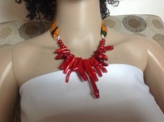 This stunning Necklace set is just beautiful and can compliment any outfit, dressy or casual. Made from bright African fabric and Red Coral Beads *It measurement is about 5 inches without the fabric closure * It comes with 1 1/8 button earrings with silver plated post and back * It is made in USA Please feel free to contact me if you hope to know any other details. For any question please contact me. Thank you for visiting my shop Follow this Link to Our Bridal Collection https://www.etsy.com/sh Vibrant Red Jewelry With Colorful Beads, Vibrant Red Beaded Necklace For Gift, Vibrant Red Beaded Necklace, Festive Red Coral Necklace, Handmade Vibrant Red Beaded Necklaces, Vibrant Red Handmade Beaded Necklace, Handmade Vibrant Red Beaded Necklace, Fabric Choker Necklace, Ankara Necklace