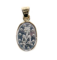 A hand-made piece of jewelry that honors Our Lady of the Miraculous Medal Classic, sturdy, and evocative Mexican medal Genuine silver from Mexico and a 14k solid gold bezel. The elegance of the medal is enhanced by the two-tone metals The medal is a work of art and unique, but it's appealing to everyone One of the devotional medals that are worn the most often across the country is the Our Lady of the Miraculous Medal. The narrative of the medal's inception begins in Paris, France, where three a Spiritual Engraved White Gold Jewelry, Engraved Spiritual White Gold Jewelry, Engraved White Gold Spiritual Jewelry, Spiritual Hallmarked Oval Pendant Jewelry, Symbolic Yellow Gold Oval Pendant Jewelry, Sterling Silver Spiritual Jewelry For Memorial, Engraved White Gold Spiritual Jewelry And Charms, Etched Sterling Silver Jewelry In Yellow Gold, Yellow Gold Etched Sterling Silver Jewelry