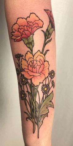 a tattoo with flowers on the leg