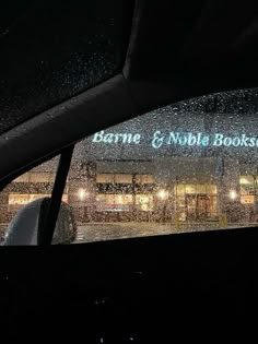 the inside of a car with rain falling on it