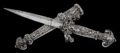 an intricately designed knife with ornate carvings on the blade and handle is shown against a black background