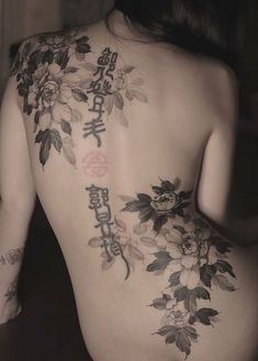 the back of a woman's body with flowers on it