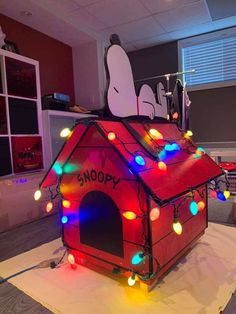 a lit up dog house in the middle of a room