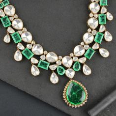 92.5 Silver, Victorian Necklace set studded with emerald lookalike gemstones. Victorian jewelry is constantly perceived as an everlasting jewelry style. Victorian jewelery is the style of the Victorian era that remains prominent in its design and composition.  Necklace: Height-240 mm width-165 mm Earrings: Height-55 mm width-33 mm Exquisite Jeweled Emerald Necklace For Anniversary, Luxury Jeweled Emerald Jewelry, Hallmarked Emerald Wedding Necklace, Emerald Stone Necklaces In Fine Jewelry Style, Green Jeweled Necklace For Anniversary, Green Jeweled Necklaces For Anniversary, Emerald Necklace With Diamonds And 17 Jewels, Emerald Necklace For Wedding, Exquisite Hand Set Emerald Necklace