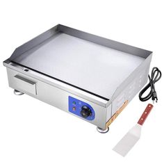 an electric griddle grill on a white background with a red handle next to it