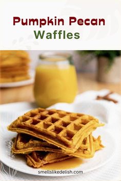 pumpkin pecan waffles on a white plate with orange juice in the background