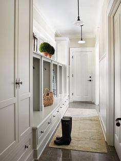 an image of a long hallway with white cabinets