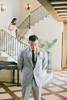 a man in a suit and tie standing next to a woman in a wedding dress