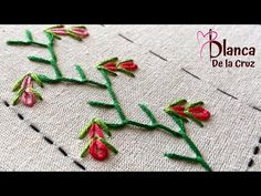 a close up of a piece of cloth with stitching on it and flowers in the middle