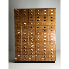 a large wooden filing cabinet with many drawers