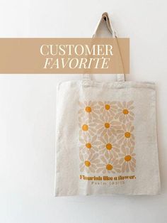 a tote bag hanging on the wall with an advertise for customer favorite