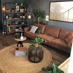 a living room filled with lots of furniture next to a wall mounted shelf and potted plants