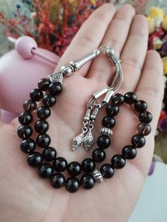 ✔️ This top quality dark black tasbih is made of 8 mm round cut smoky quartz beads. ✔️ It is a premium quality and striking natural stone tesbih. ✔️ Natural color rosary ✔️ Natural AAA Smoky Quartz Stone ✔️ Each order comes in a special free gift box. ✔️ PLEASE CLICK THE LINK FOR ALL PRAYER BEADS MODELS https://www.etsy.com/shop/GoodJewelsofYazmasal Note: As a natural feature the stones beads may have some variations. SHIPPING: United States (Standart/DHL eCommerce/usps): 7-10 business days Unit Traditional Black Beads For Gift, Handmade Black Spiritual Beads, Handmade Spiritual Black Beads, Black 8mm Beads For Gifts, Spiritual Black Beads For Jewelry Making, Black Hand-strung Beads For Jewelry Making, Black Hand-strung Beads As Gift, Black Hand-strung Beads Gift, Traditional Black Rosary With 8mm Beads