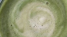 a pan filled with green liquid on top of a stove