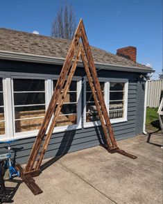 an upside down wooden frame in front of a house