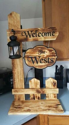 a wooden sign that says welcome to the wests on top of a kitchen counter