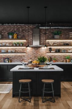 an open kitchen with black cabinets and white counter tops is featured in the article ideas of work kitchens 2020