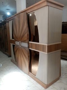 a large wooden cabinet sitting on top of a tiled floor