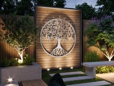 an outdoor garden with trees and benches lit up by lights on the side of it