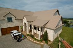 an aerial view of a house with a truck parked in the driveway