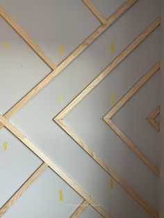 an unfinished room with white walls and yellow tape on the wall, as well as wood framing