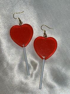 Cute, HEART + GLITTER + LOLLIPOP earrings. For pierced ears. Perfect for Valentines and Halloween. Great Birthday gift. Colors are red, white,  and gold. Has a little bit of scratches. sold as is. Style: Hipster, punk, Kitsch, goth, gothic, punk, Kawaii, Boho, Hippie, Retro. approximate measurements: body of earrings: 3 1/8" L x 1 3/8"W drop of earrings: 4" L Heart Shaped Lollipops, Punk Kawaii, Lollipop Earrings, Heart Lollipop, Heart Glitter, Earrings Heart, Gothic Punk, Great Birthday Gifts, Big Earrings