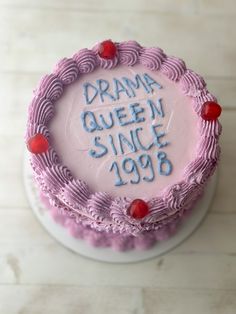 a cake with writing on it that says drama queen since 1989 and surrounded by cherries