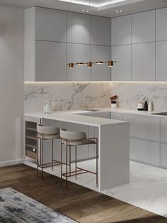 a modern kitchen with marble counter tops and bar stools