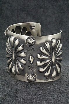 This stunning sterling silver bracelet was made by Navajo silversmith Elvira Bill. The inside is signed Elvira Bill and stamped sterling.Size: 5 7/8" (will fit up to a 7 1/4" wrist)Gap: 1 3/8"Width: 2"Free shipping on all orders! We ship with USPS and always include tracking. All orders ship within a day of payment.Returns are accepted up to 30 days after you receive your order. Just send us a message. Our shop offers cash back or store credit. The item must be returned in new condition. Southwestern Style Silver Round Cuff Bracelet, Southwestern Silver Bracelets With Concho, Artisan Sterling Silver Concho Cuff Bracelet, Artisan Silver Concho Cuff Bracelet, American Jewelry, Sterling Silver Bracelet, Native American Jewelry, Sterling Silver Bracelets, Native American