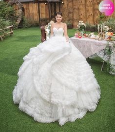 a woman in a wedding dress sitting at a table